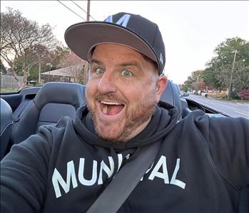 Man with a big smile enjoying a car ride