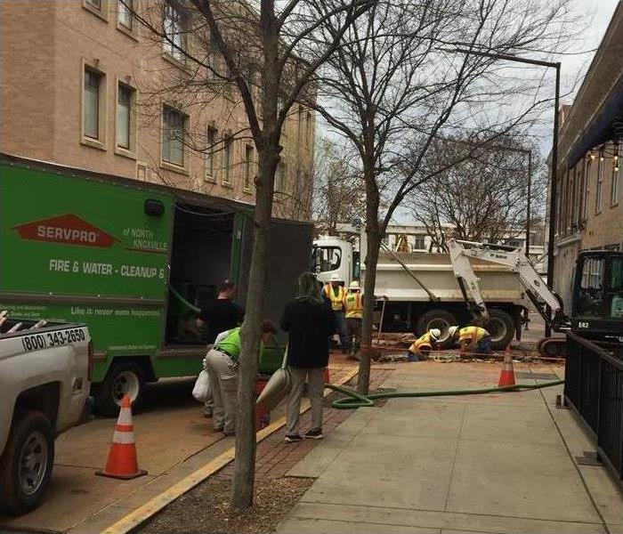 Outside a building, the SERVPRO team is unloading machinery to enter a building.